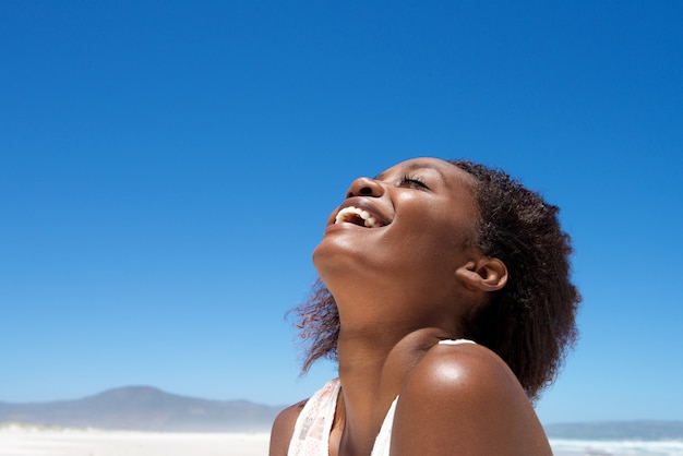 Beautiful young african woman laughing outdoors