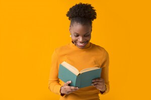Beautiful young african woman with a book