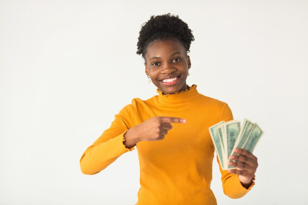 beautiful young African woman with dollars