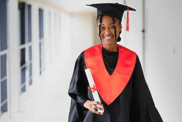 Beautiful young afro american graduate holding diploma