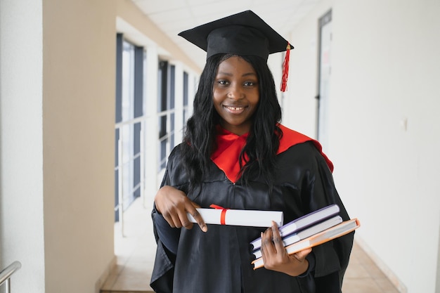 Beautiful young afro american graduate holding diploma