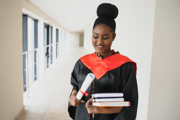 Beautiful young afro american graduate holding diploma