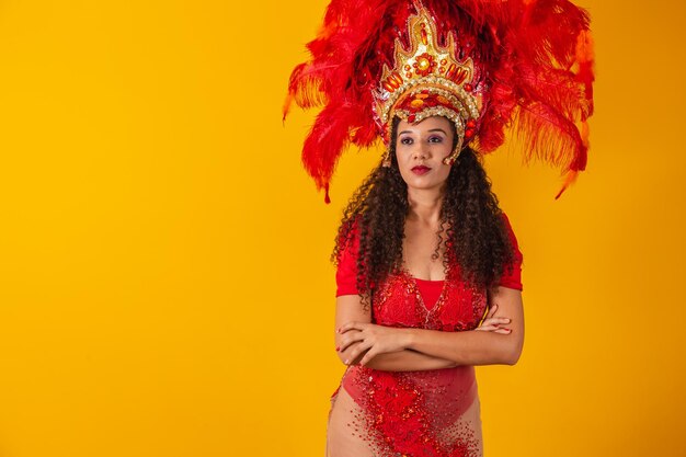 Beautiful young afro woman in carnival costume with arms crossed.