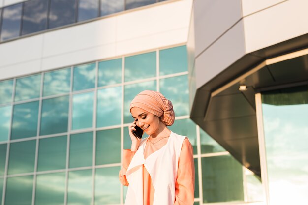 Beautiful young arabian woman talking on cell phone.