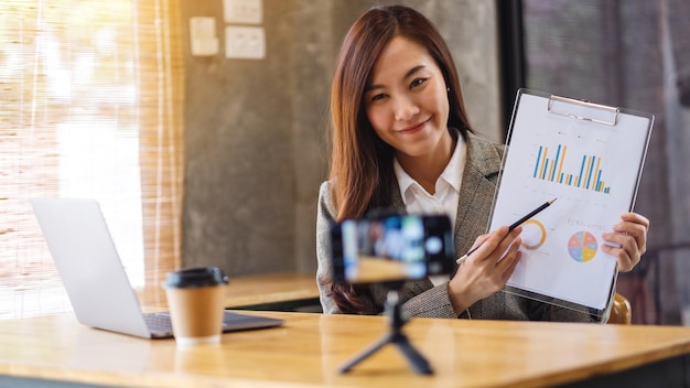 A beautiful young asian businesswoman teaching business class , online meeting concept