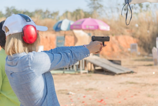 Beautiful young Asian practice shooting outdoor