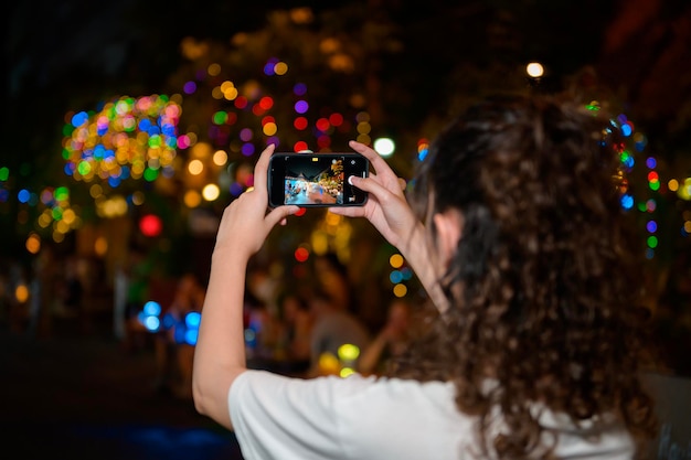 Beautiful young Asian tourist woman on vacation sightseeing and exploring at Khao San road at night