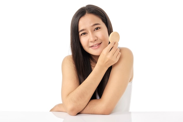 Beautiful young Asian woman cleaning beauty face, using cotton pads, cleansing lotion, and facial toner for removing makeup. A beautiful girl has nice facial skin. skincare concept.