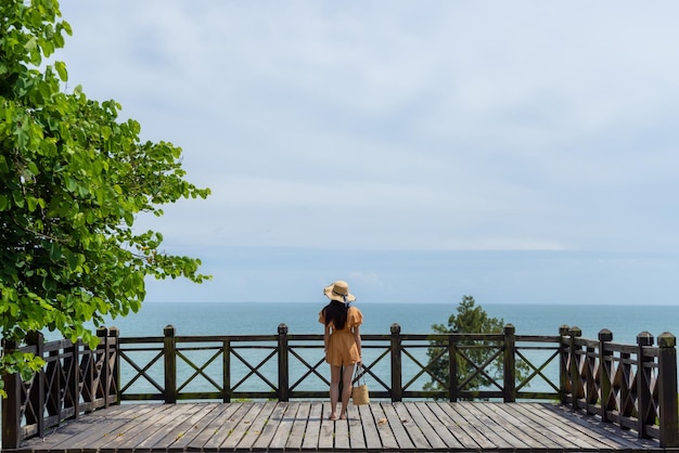 Beautiful young asian woman look at the sea