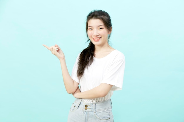 Beautiful young Asian woman portrait Studio shot isolated on Blue background