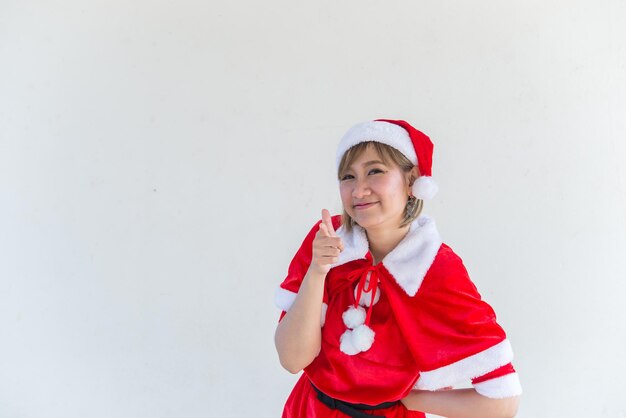 Beautiful young asian woman in Santa Claus clothes on white backgroundThailand peopleSent happiness for childrenMerry christmasWelcome to winterHappy woman concept