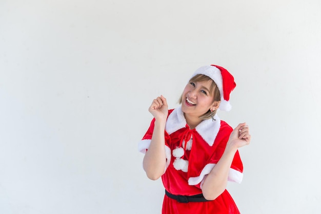 Beautiful young asian woman in Santa Claus clothes on white backgroundThailand peopleSent happiness for childrenMerry christmasWelcome to winterHappy woman concept