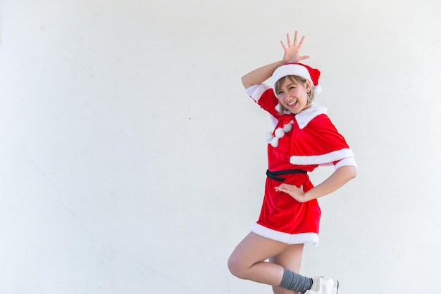 Beautiful young asian woman in Santa Claus clothes on white backgroundThailand peopleSent happiness for childrenMerry christmasWelcome to winterHappy woman concept