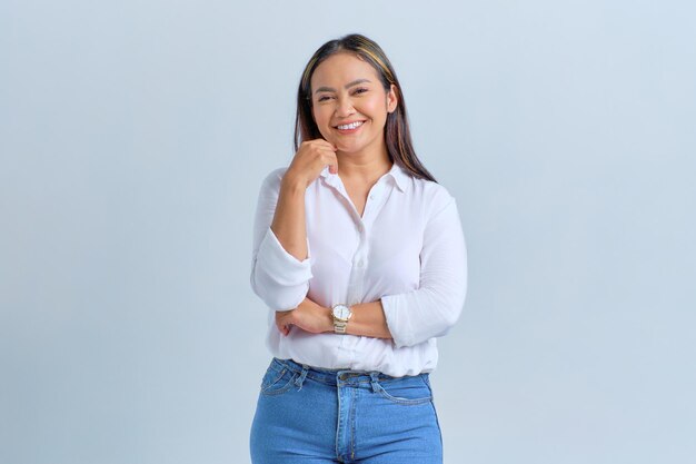 Bella giovane donna asiatica sorridente e guardando fiducioso isolato su sfondo bianco