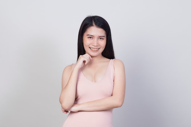 Beautiful young Asian woman smiling portrait a girl with wear pink dress have a fun and happy of positive with success isolated on white background