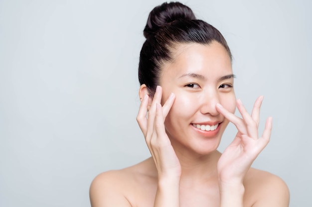 Beautiful young asian woman with clean fresh skin on white background. Asian women portrait.