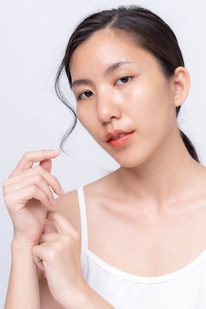 Beautiful young asian woman with clean fresh skin on white background. Asian women portrait.