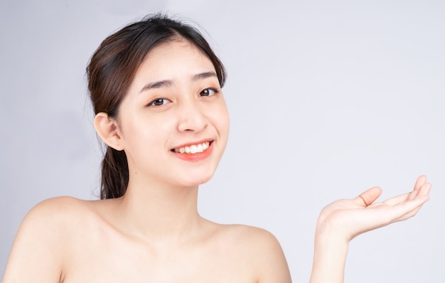 Beautiful young asian woman with clean fresh skin on white background,