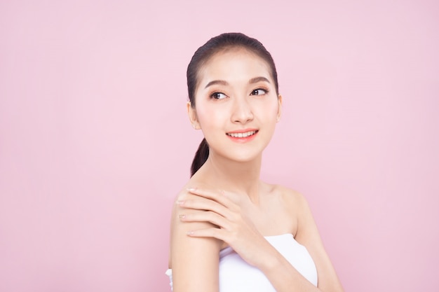 Beautiful Young Asian woman with clean fresh white skin face in beauty pose.