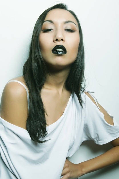 Beautiful young asian woman with perfect skin and black lipstick, fashion shoot