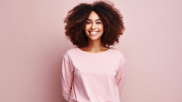 Beautiful young black woman posing on a light pink studio background with room for text