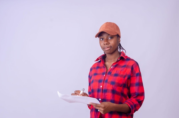 Beautiful young black woman smiling while holding a blank pad