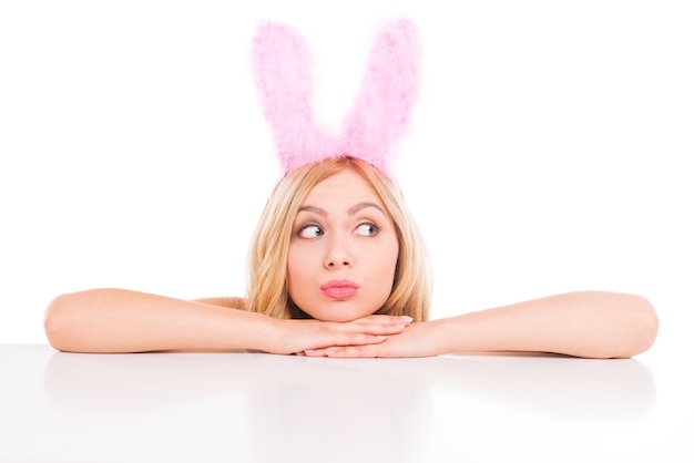 Beautiful young blond hair woman with rabbit ears leaning