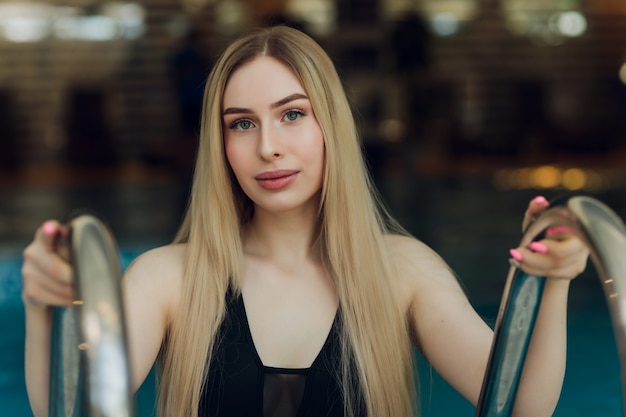 Beautiful young blond woman at swimming pool