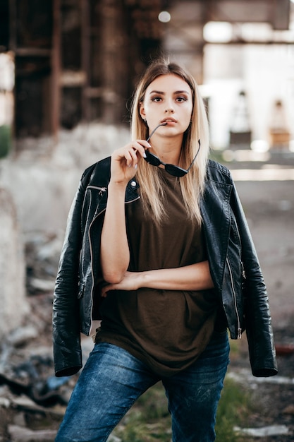 Beautiful young blonde girl  in a blank green military T-shirt and Leather Jacket