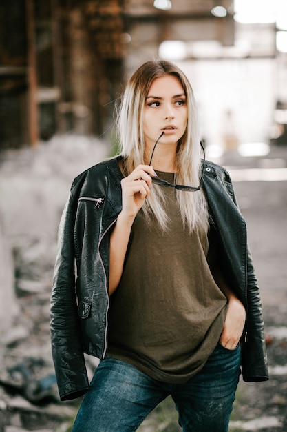 Beautiful young blonde girl  in a blank green military T-shirt and Leather Jacket