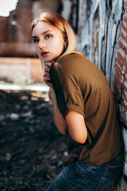 Beautiful young blonde girl  in a blank green military T-shirt