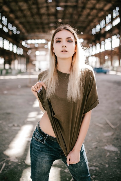 Beautiful young blonde girl  in a blank green T-shirt