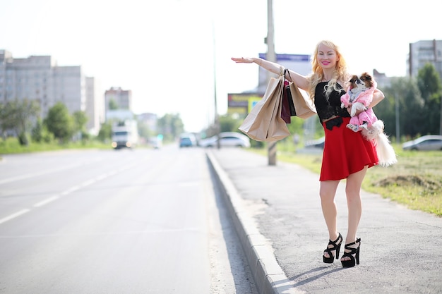 Beautiful young blonde on a walk with little dog