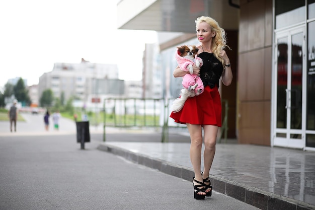 Beautiful young blonde on a walk with little dog