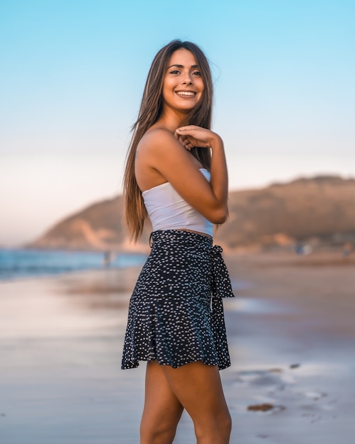 Beautiful young brunette woman gently smiling in San Sebastian, Spain