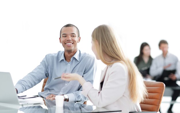 Beautiful young business partners are using a laptop, discussing documents.photo with copy space