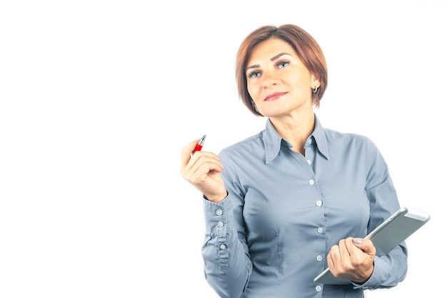 Beautiful young business woman with a red pen and notebook in hands on a white background