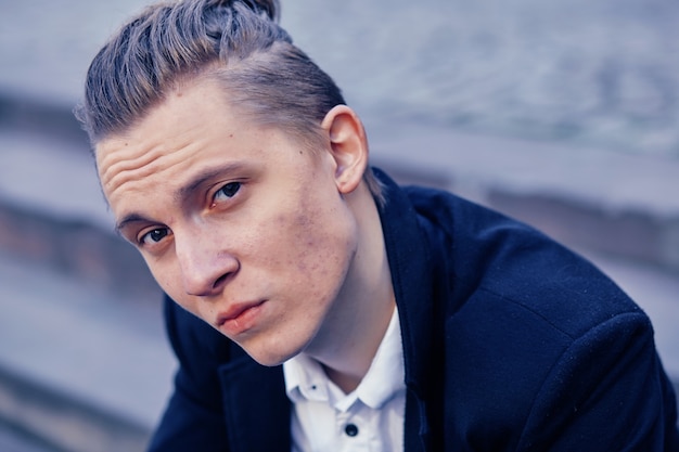 Beautiful young businessman sitting on a staircase