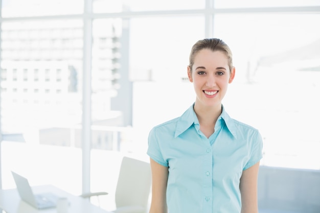 Beautiful young businesswoman posing in her office