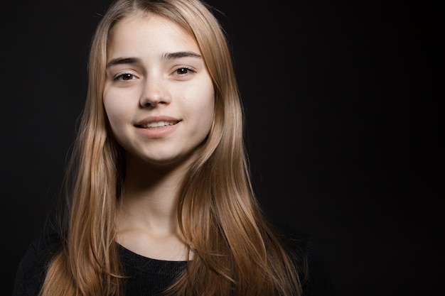 Beautiful young caucasian woman portrait on black background