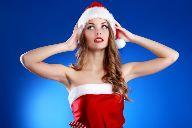 Beautiful young christmas woman making a funny expression