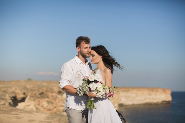 Beautiful young couple on a date. The guy hugging and kissing a girl.