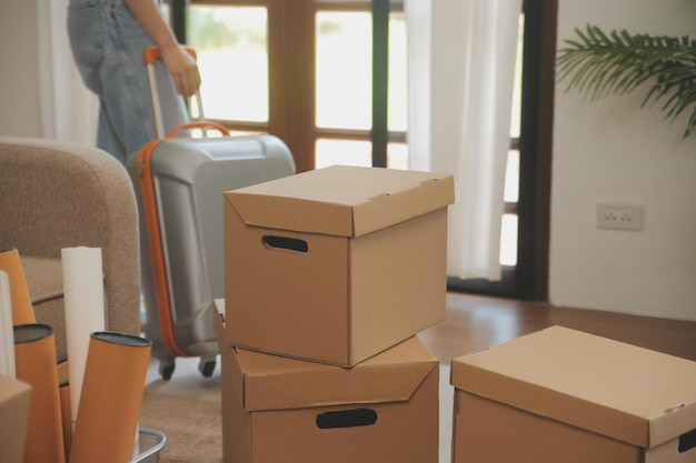 Beautiful young couple in love having fun unpacking things from cardboard boxes while moving in together in their new apartment