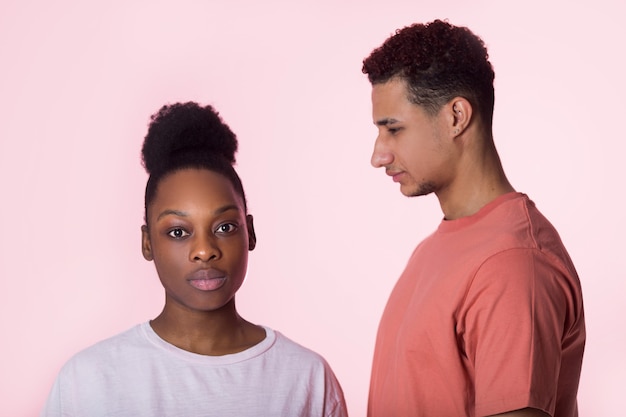 beautiful young couple man and woman on pink background