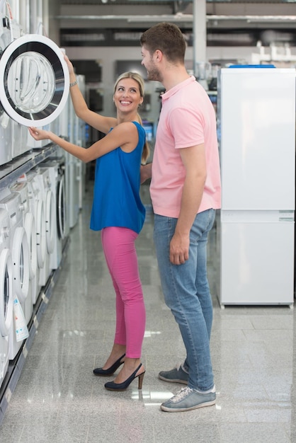 Beautiful Young Couple Shopping For Washing Machine In Produce Department Of A Grocery Store  Supermarket  Shallow Deep Of Field