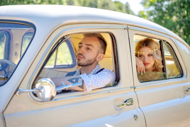 Beautiful young couple sitting in car romantic relationship