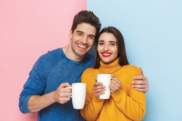 Beautiful young couple standing isolated