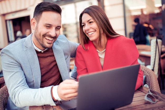 Beautiful young couple using laptop