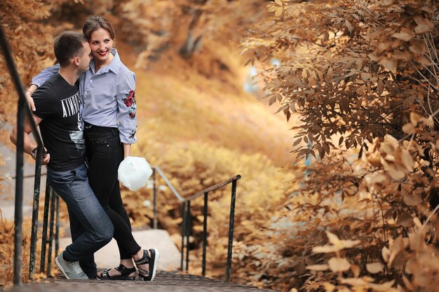 Beautiful young couple on a walk in the autumn park