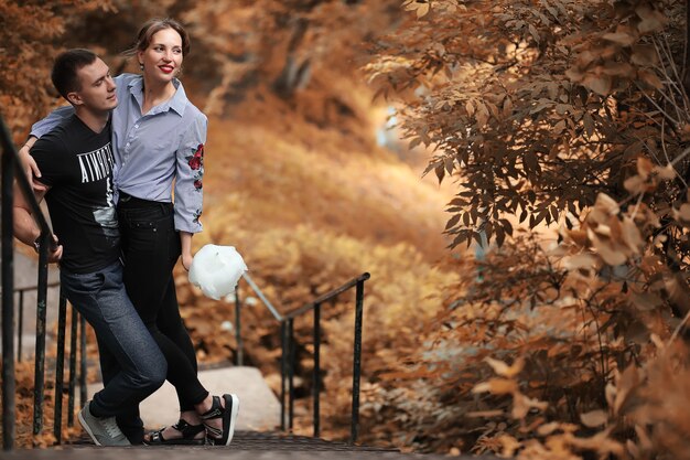 Beautiful young couple on a walk in the autumn park